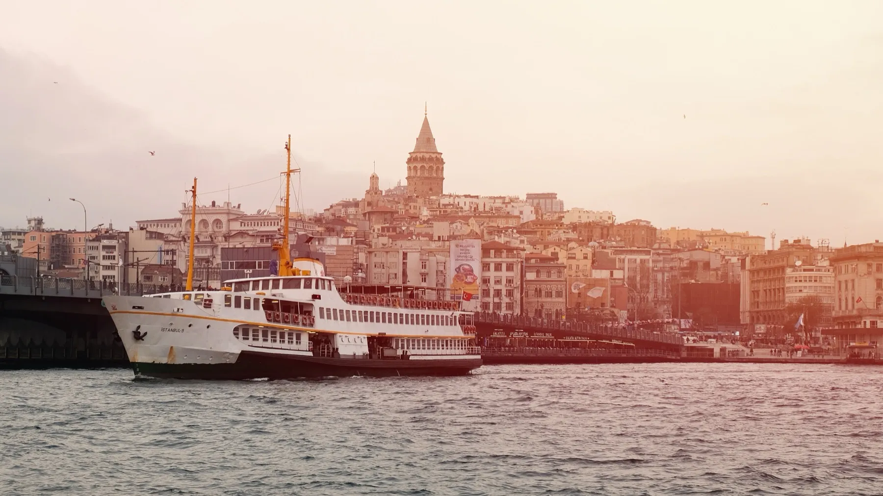 A city ferry on the Golden Horn with Galata Tower behind